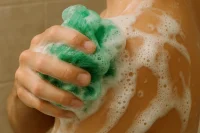 Shower sponge creating lots of foam with Palm Oil Free shower gel
