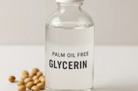 Clear bottle of POF glycerin with soy beans scattered at the base