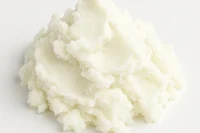 Shea butter refined organic piled on a white back ground
