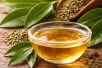 Cinnamon leaf organic essential oil in a bowl with cinnamon leaves around