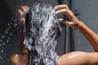 Tanned lady washing her dark hair