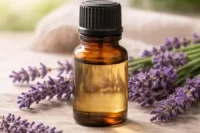 Organic lavender essential oil in amber glass bottle with lavender flowers